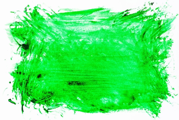 Primer plano de una mancha de pintura verde sobre un fondo blanco