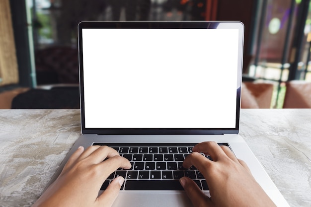 Primer plano mano escribiendo la computadora del teclado en la cafetería