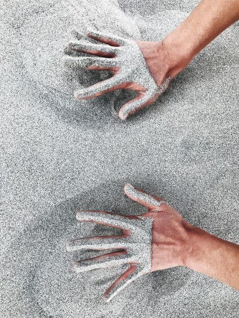 Foto primer plano de la mano humana en la arena