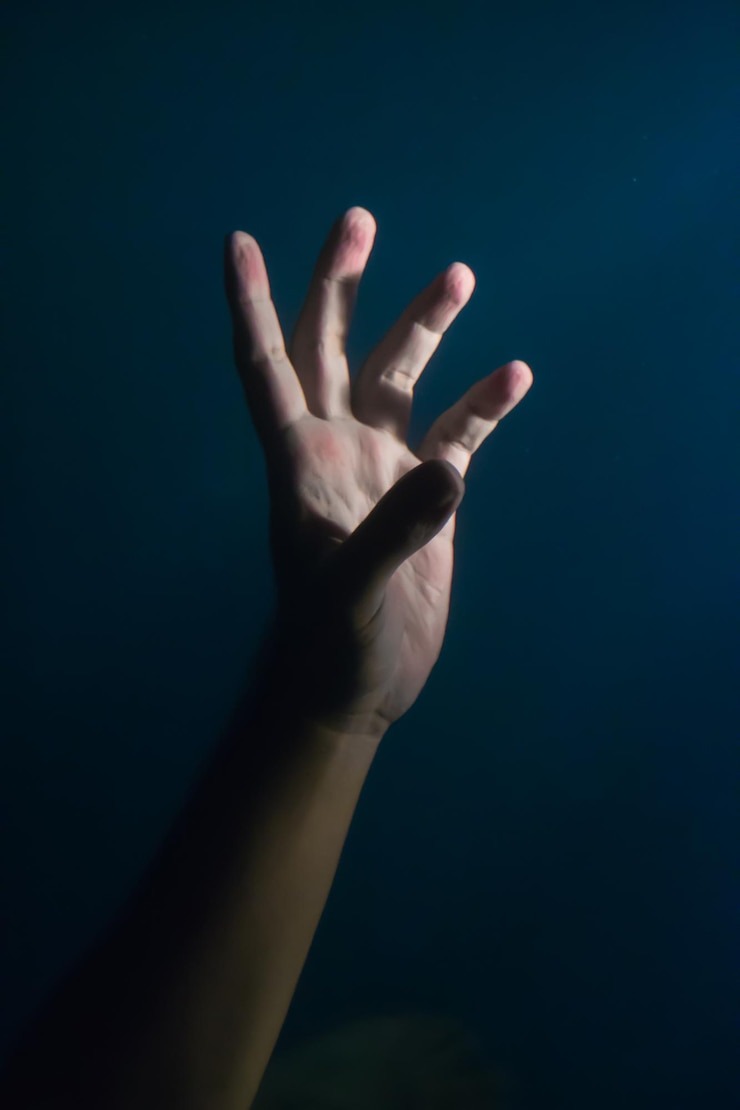 Foto primer plano de la mano sobre un fondo negro