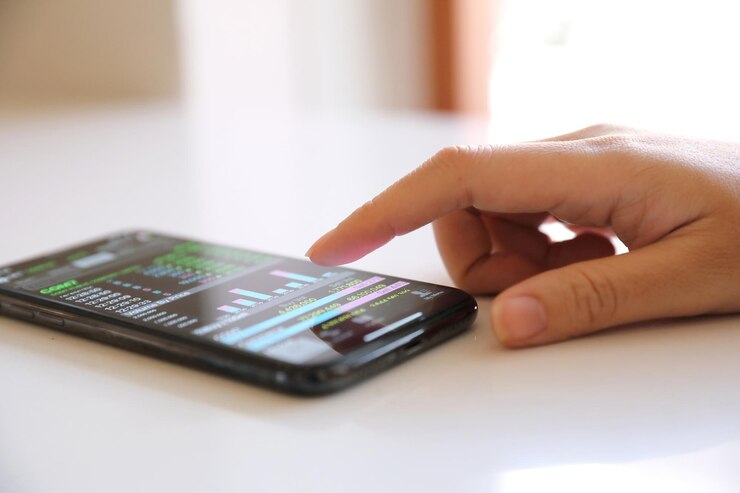 Foto primer plano de la mano usando el teléfono inteligente en la mesa