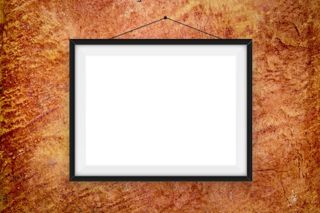 Foto primer plano de un marco de imágenes en blanco colgado en la pared
