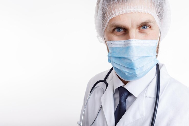 Primer plano de un médico masculino con máscara blanca y gorra médica