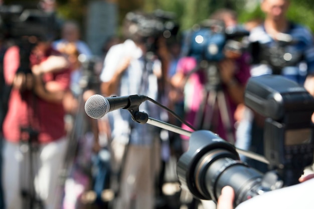 Foto un primer plano del micrófono contra los periodistas
