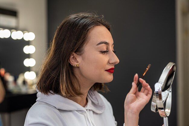 Primer plano de una modelo de belleza facial femenina con piel suave haciendo teñido de cejas y laminación