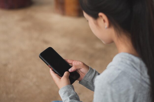 Foto primer plano de una mujer joven que charla en línea con su amiga en una conversación en línea al aire libre, conexión y concepto de redes sociales, espacio para copiar luz del atardecer para texto individual