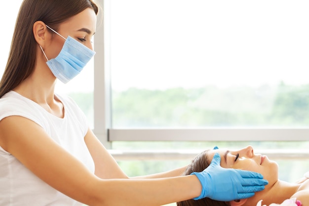 Primer plano de una mujer joven recibiendo un tratamiento de masaje spa en el salón de belleza spa