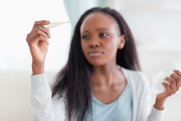 Primer plano de mujer que mide la temperatura