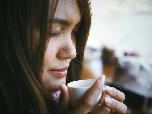 Foto primer plano de una mujer con una taza de café