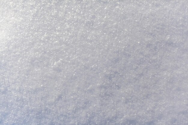 Primer plano de nieve blanca limpia Fondo de invierno Superficie de nieve Textura de nieve blanca esponjosa fresca
