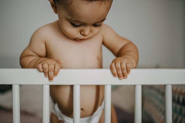 Primer plano de un niño sin camisa de pie en casa