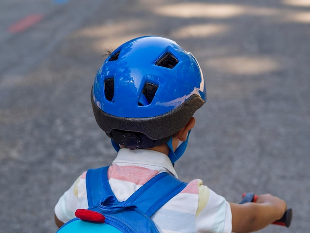 Primer plano de un niño con casco en bicicleta