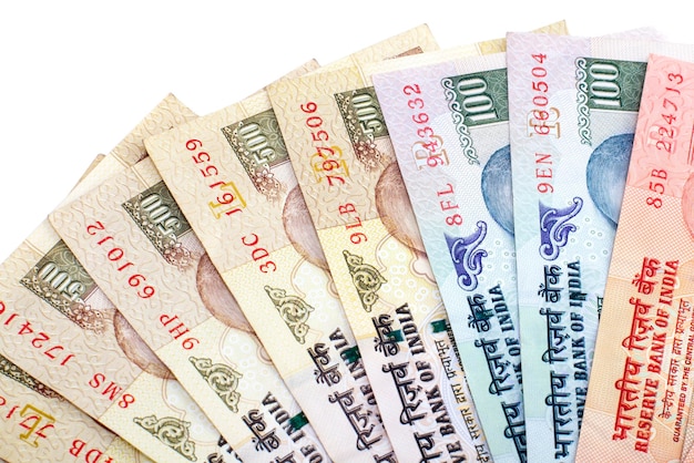 Foto primer plano de papel moneda indio organizado sobre un fondo blanco