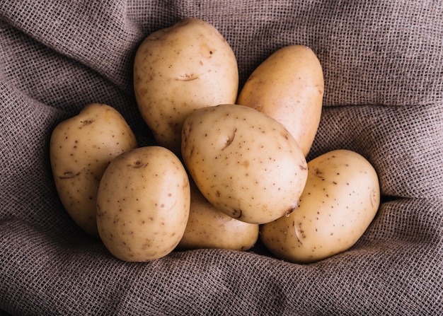 Primer plano de patatas crudas en textil saco
