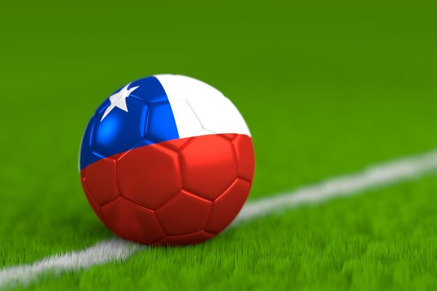 Foto primer plano de una pelota de fútbol pintada con una bandera en un campo de juego cubierto de hierba