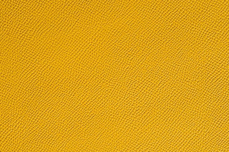 Primer plano de una perfecta textura de cuero amarillo para el fondo
