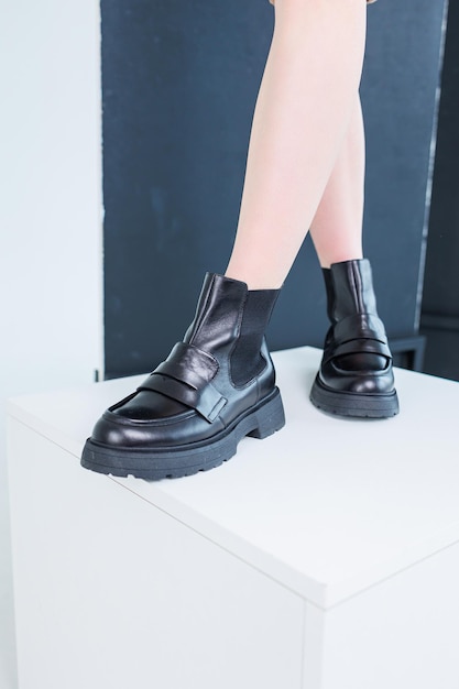 Primer plano de piernas femeninas en botas chelsea de cuero negro Zapatos casuales de primavera cómodos para mujer Botas chelsea de primavera para mujer negras