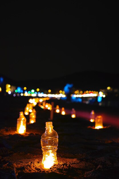 Foto primer plano de una playa iluminada contra el cielo nocturno