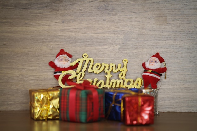 Primer plano de regalos de Navidad y decoración en la mesa contra la pared
