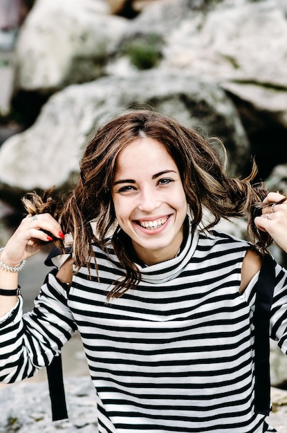 Primer plano de retrato de mujer joven morena sonriente al aire libre