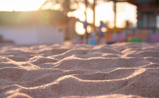 Primer plano de la superficie de arena amarilla limpia que cubre la playa junto al mar iluminada con la luz del atardecer Concepto de viajes y vacaciones