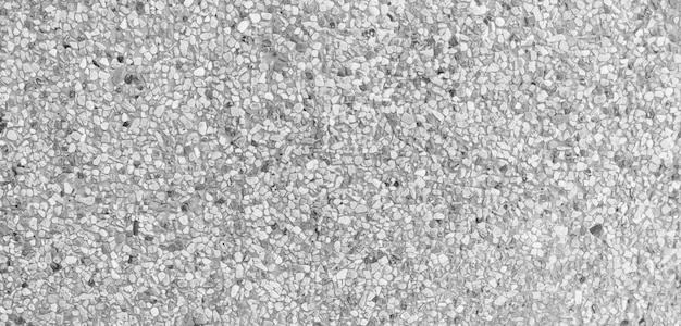 Foto un primer plano de una superficie gris y blanca con una pequeña roca sobre ella.