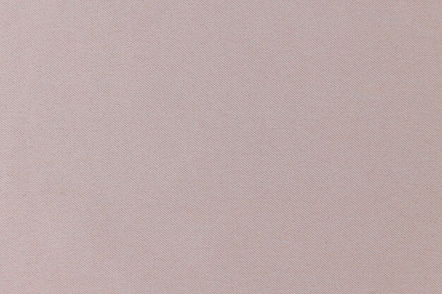 Primer plano de una superficie rosa pastel lisa con una textura sutil que crea una estética minimalista