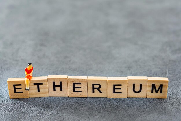Primer plano del texto de ethereum y la estatuilla femenina en la mesa