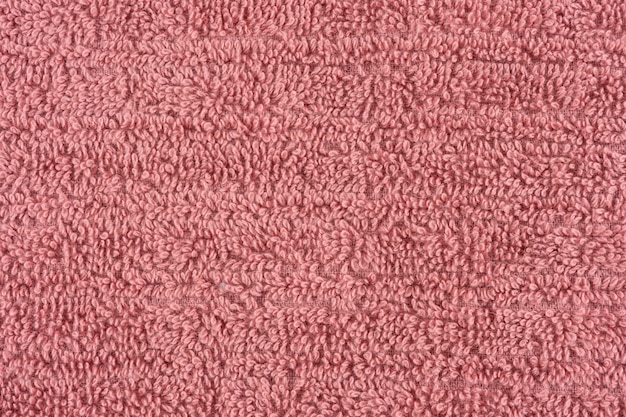 Primer plano de una toalla rosa. telón de fondo de detalles textiles.