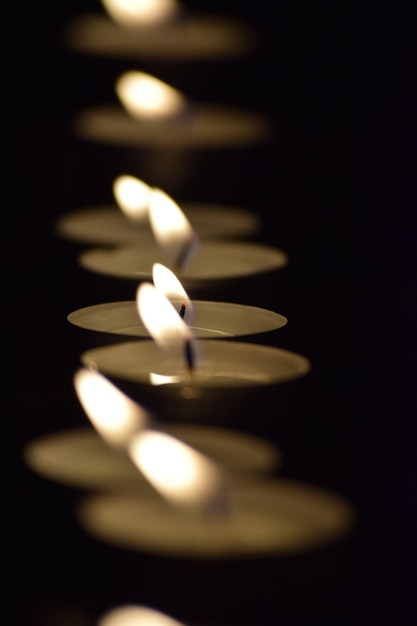 Foto primer plano de velas iluminadas sobre un fondo negro