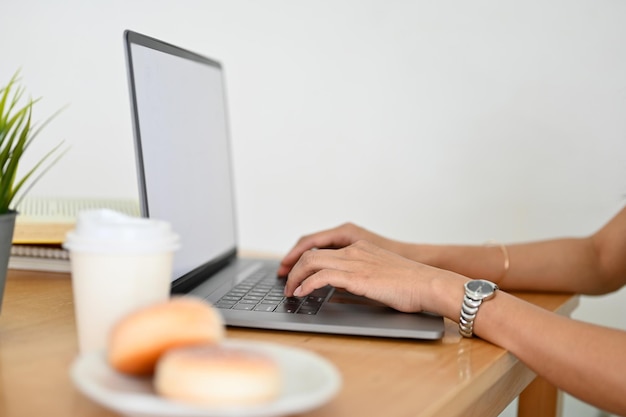 Primer plano de la vista trasera de una mujer de negocios o una mujer que trabaja con una computadora portátil