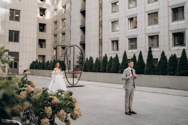 Foto primer vistazo del novio y la novia en la calle mujer con vestido de novia novio con traje al aire libre concepto de matrimonio y amor