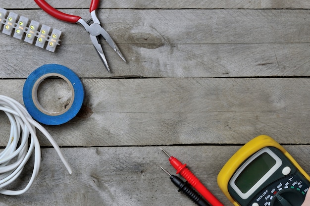 Probador y herramienta electro sobre un fondo de madera. copia espacio