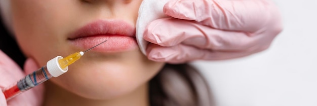 Procedimento de correção da forma labial em um salão de cosmetologia O especialista faz uma injeção nos lábios do paciente Aumento labial