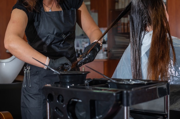 Proceso de coloración del cabello en el estudio de peluquería por un estilista o peluquero