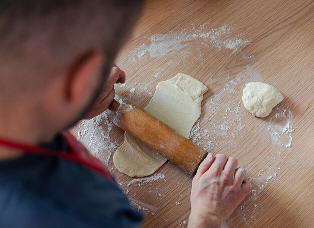 Foto el proceso de hacer pastel de chocolate por un hombre en la cocina.