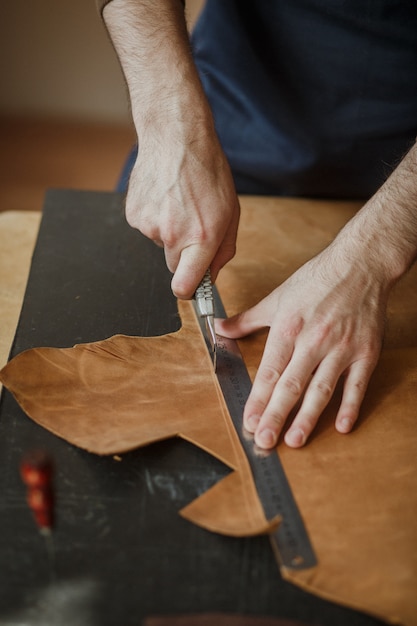 Proceso de revelar pieza de cuero en taller.