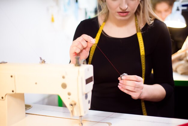 Proceso de trabajo con máquina de coser en un taller.