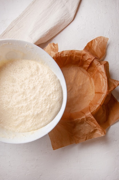 Processo de cozimento Cheesecake queimado basco. A massa é colocada em uma assadeira coberta com papel. Receita passo a passo vista de cima plana.