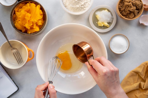 Processo de cozinhar muffins de bolo de abóbora ou sobremesa de abóbora vista superior mãos femininas receita passo a passo