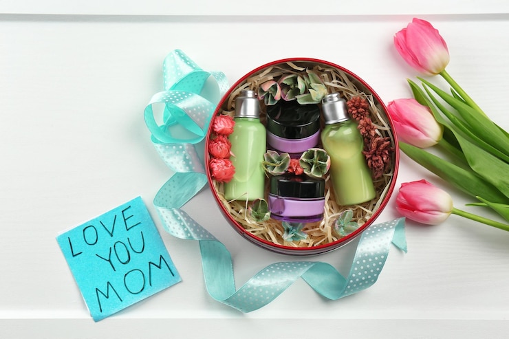 Foto produtos cosméticos em cartão de caixa de presente com as palavras "amo-te, mãe" e tulipas em fundo claro celebração do dia da mãe