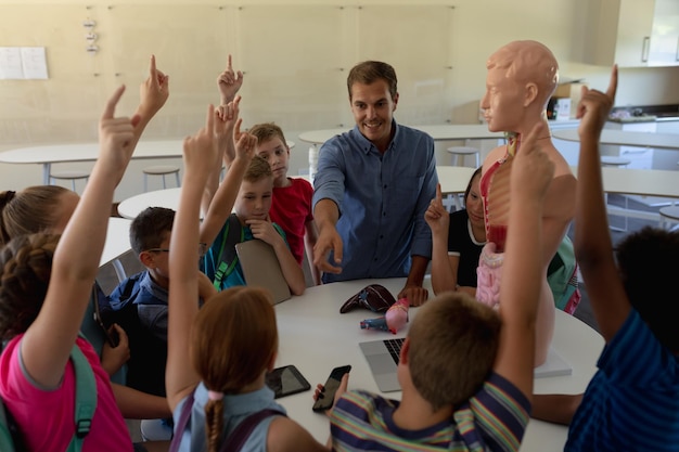 Profesor masculino usando un modelo de anatomía humana para enseñar