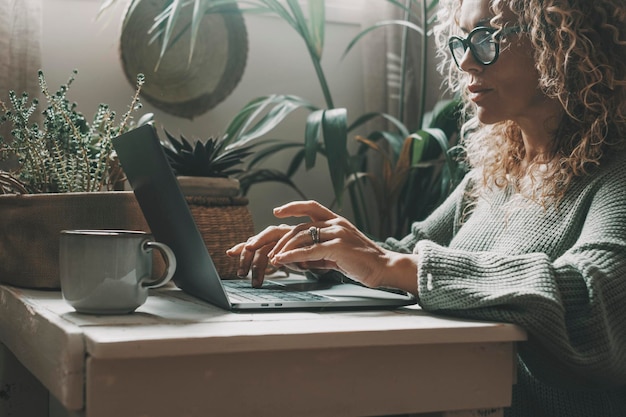 Professionelle Frau, die zu Hause am Laptop arbeitet und mit konzentriertem Ausdruck schreibt Moderne Frauen, die Computer in Online-Freizeitaktivitäten im Innenbereich verwenden Shopping oder Business Smart Work Job Freelancer