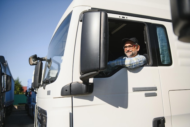 Professioneller Semi-LKW-Fahrer hinter dem Lenkrad eines klassischen LKW