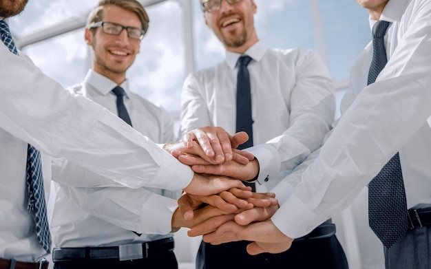 Professionelles Business-Team faltet ihre Hände zusammen Teamwork-Konzept