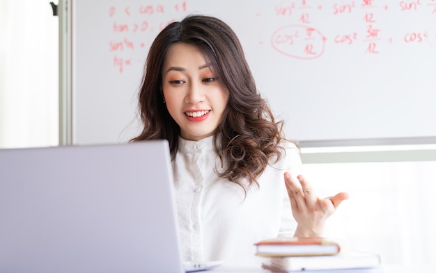 Professora asiática ensinando online em casa