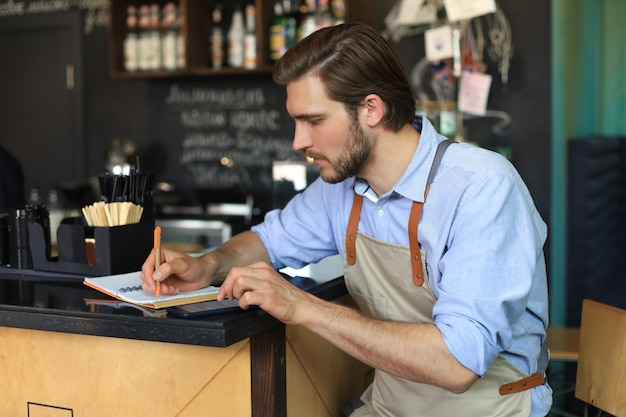 Propietario de una pequeña empresa que trabaja en su café.