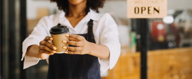 Proprietário de pequenas empresas bem-sucedidas de inicialização sme beauty girl stand com smartphone tablet no restaurante de café Retrato de mulher bronzeada asiática barista proprietário de café SME empresário vendedor conceito de negócios