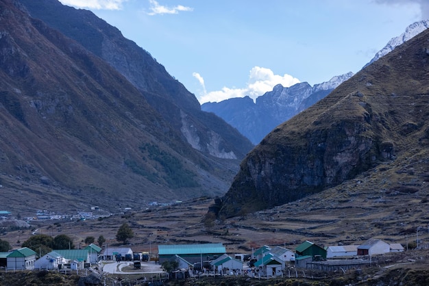 Un pueblo en las montañas con un techo verde