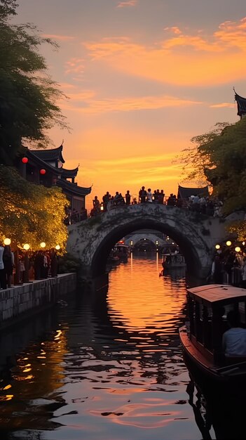 un puente con un atardecer en el fondo y un barco en el agua